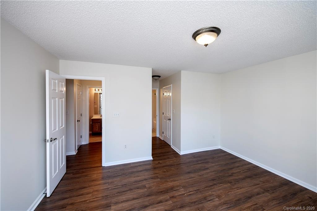 5003 Sharon Road, Unit R Charlotte, NC 28210 - Photo 16 of 23 a view of an empty room with wooden floor