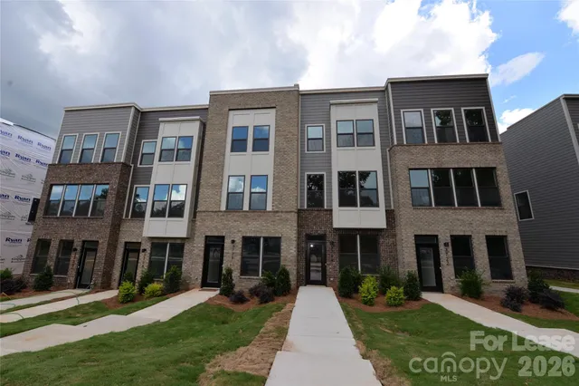 a view of a kitchen with a sink and a refrigerator