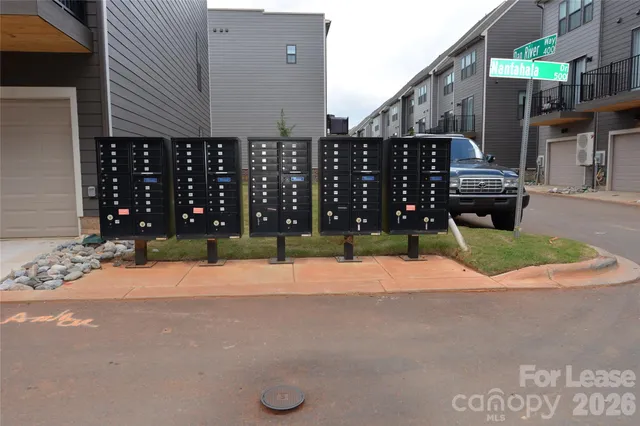 a street view with wooden fence and buildings