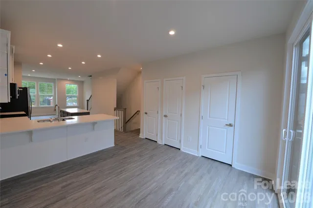 a large white kitchen with a large window