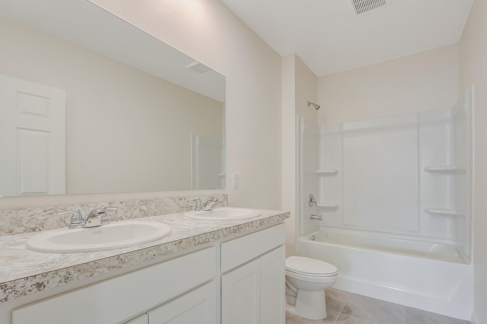 12335 Southwest Nettuno Way Port Port St. Lucie, FL 34987 - Photo 18 of 33 a bathroom with a granite countertop sink a toilet and shower