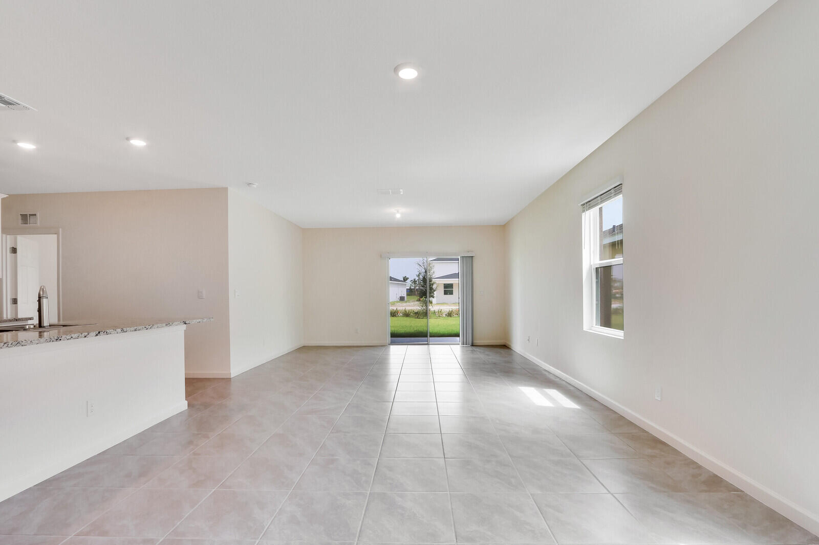 12335 Southwest Nettuno Way Port Port St. Lucie, FL 34987 - Photo 6 of 33 an empty room with windows and cabinet