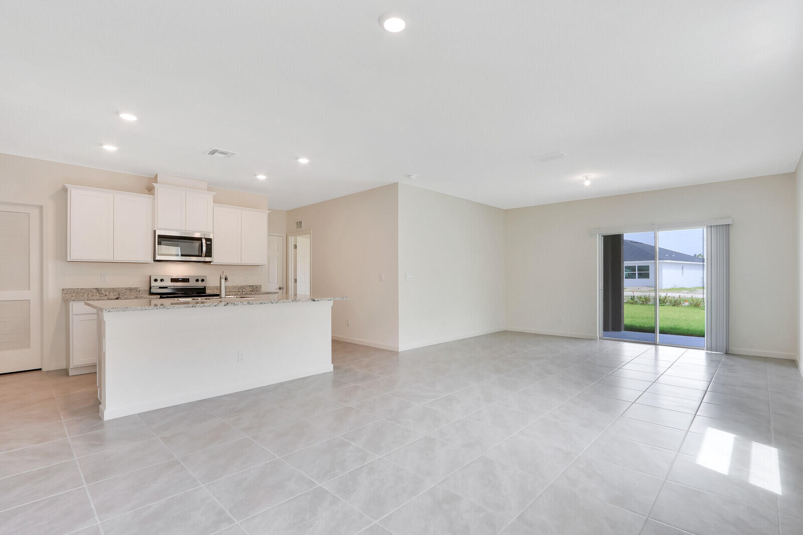 12335 Southwest Nettuno Way Port Port St. Lucie, FL 34987 - Photo 7 of 33 a view of kitchen with kitchen island and stainless steel appliances