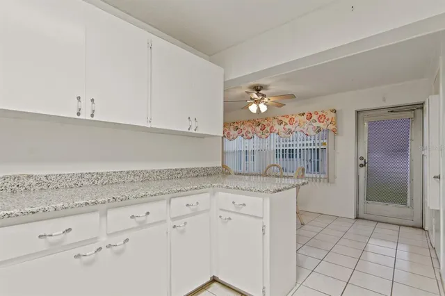 a kitchen with granite countertop a sink and cabinets