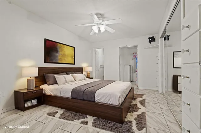 a bedroom with a large bed and a chandelier