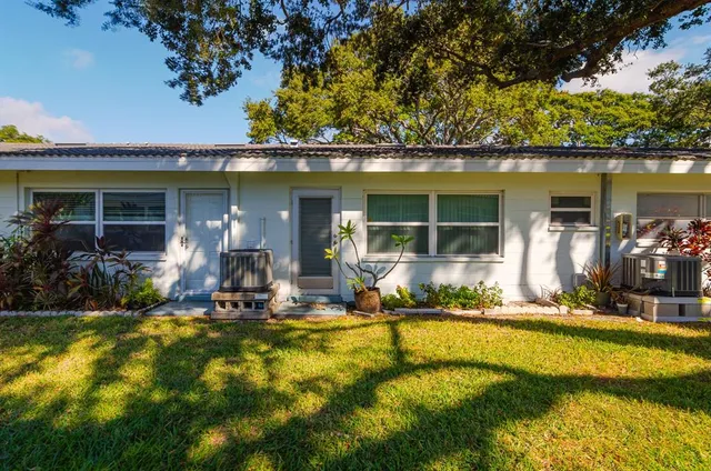 a front view of house with swimming pool and outdoor seating
