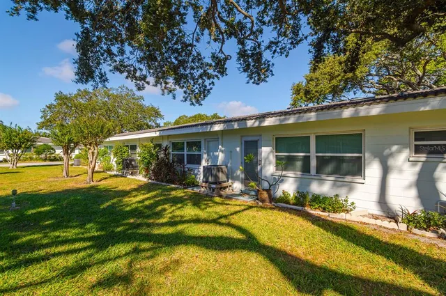 a view of a house with swimming pool and sitting area