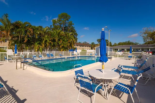 a view of a swimming pool with outdoor seating