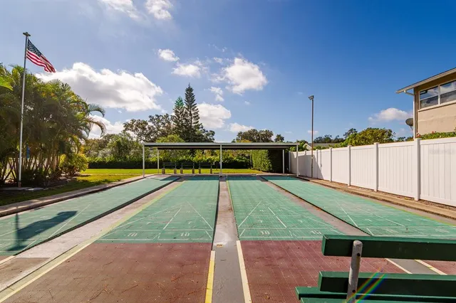 a view of a swimming pool with a chair and tables