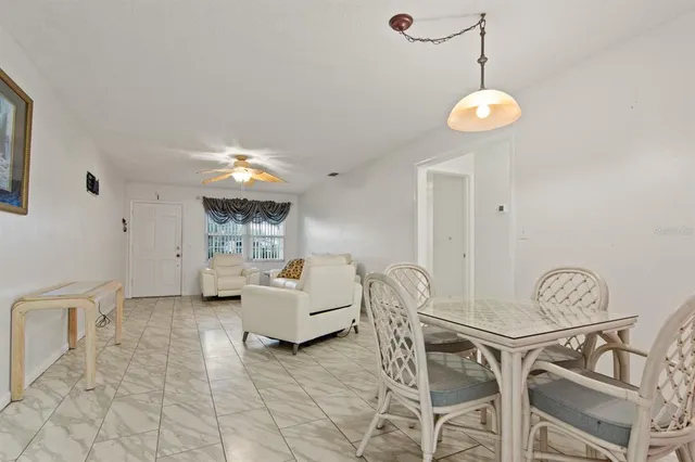 a view of a livingroom and a dining room with furniture