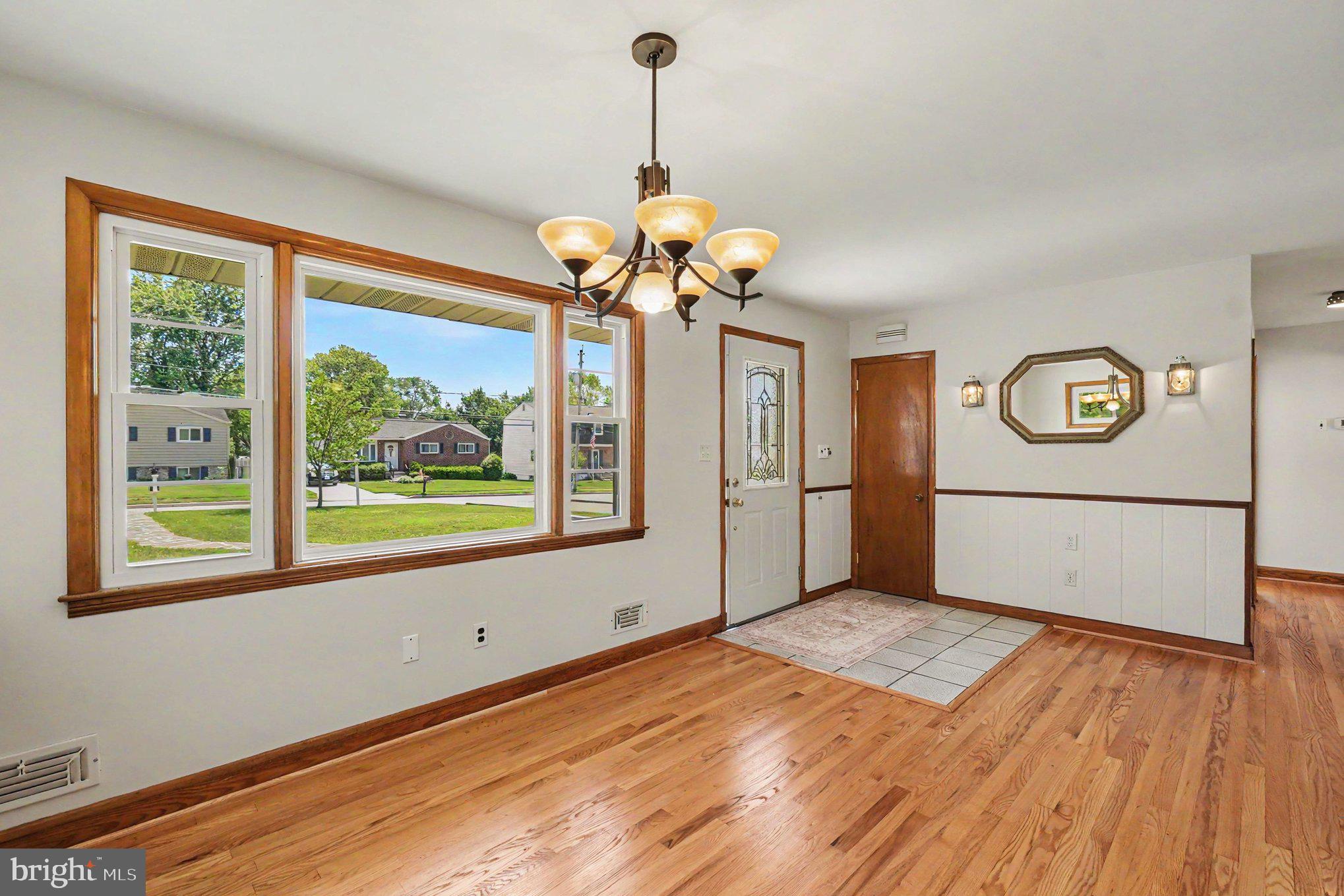 9204 Snyder Lane Perry Hall, MD 21128 - Photo 2 of 42 a view of a room with wooden floor chandelier and windows