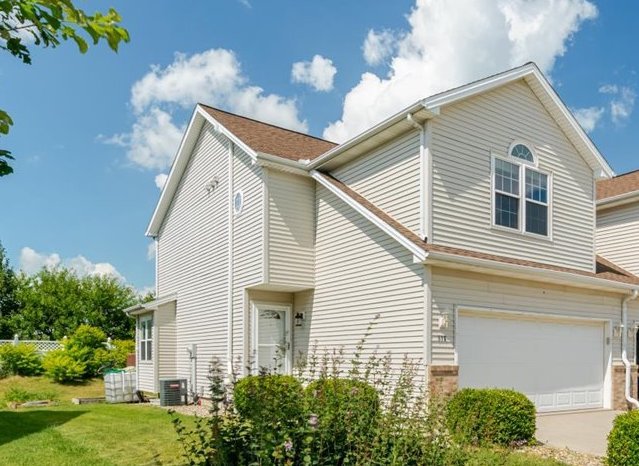 a view of a house with a yard and potted plants