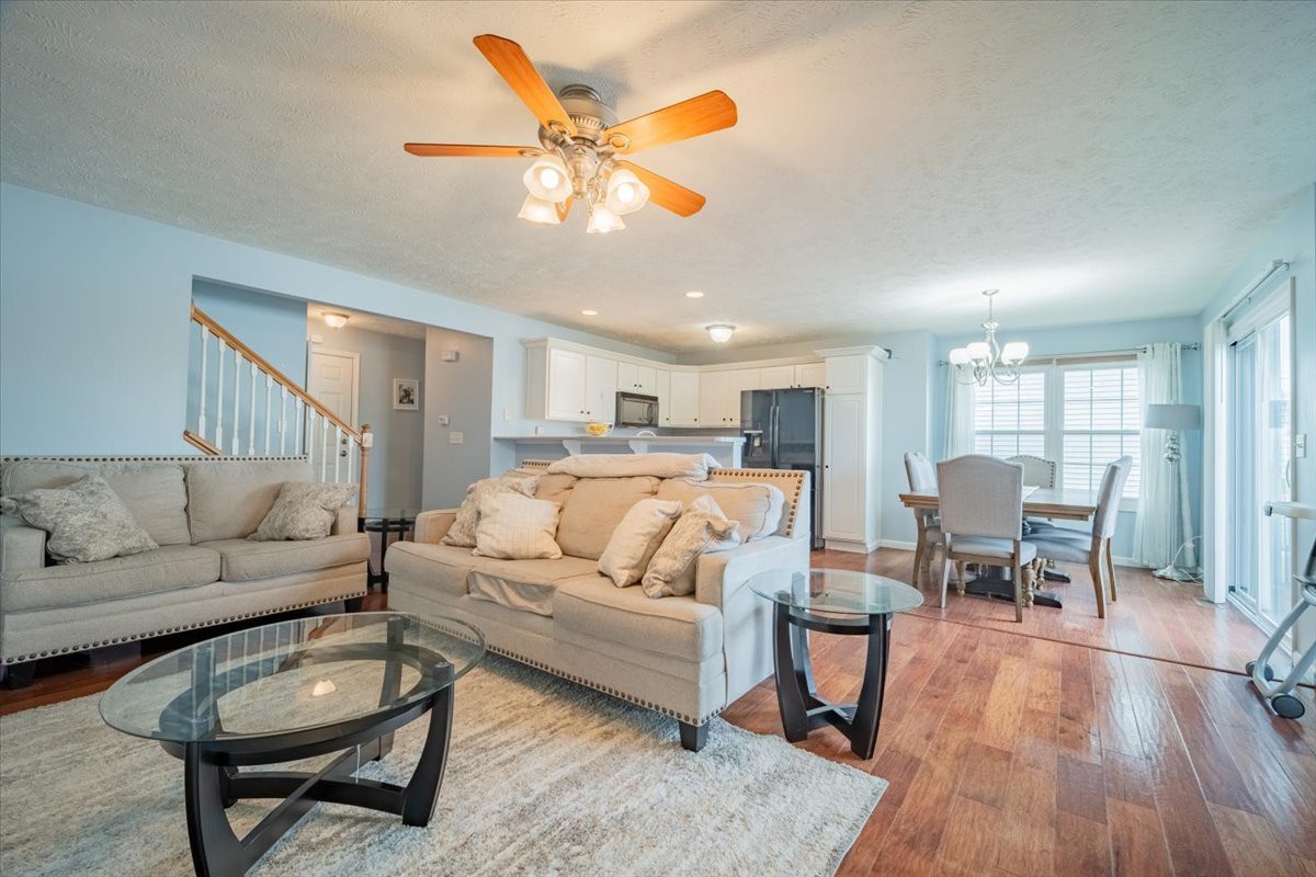 516 Wild Turkey Lane Normal, IL 61761 - Photo 3 of 26 a living room with furniture kitchen view and a wooden floor