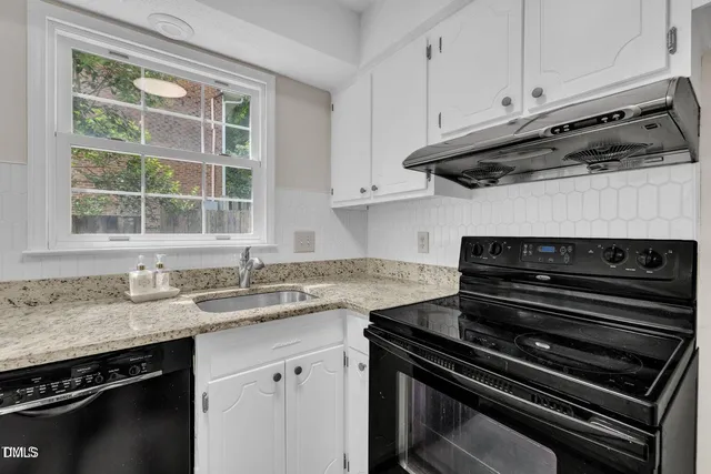 a kitchen with wooden cabinets and a stove top oven