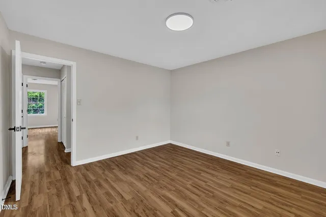 a view of a room with wooden floor