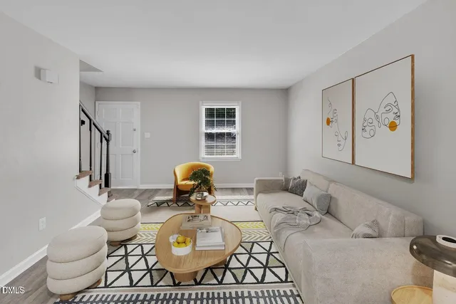 a living room with furniture and wooden floor
