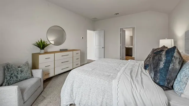 a bedroom with a bed and a dresser