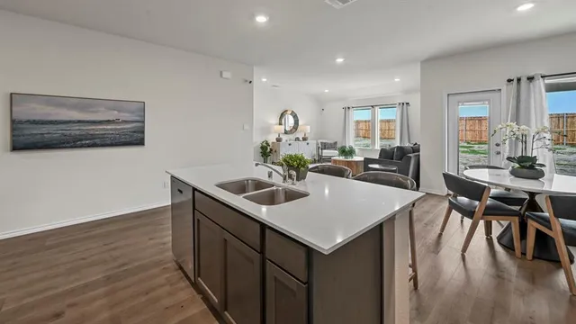 a view of kitchen island with stainless steel appliances and wooden floor