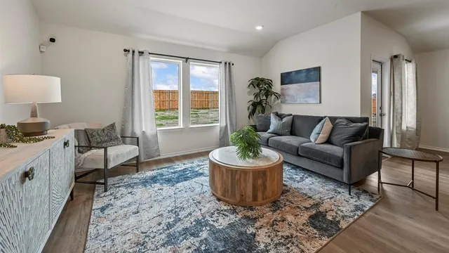 a living room with furniture and a potted plant