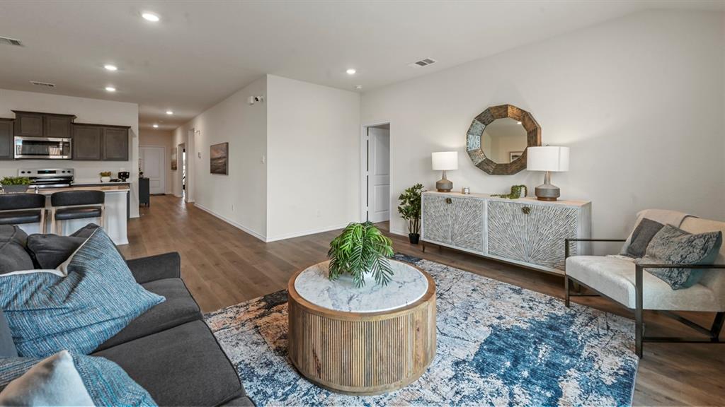 3264 Spaulding Drive Paris, TX 75460 - Photo 29 of 33 a living room with furniture a rug and kitchen view
