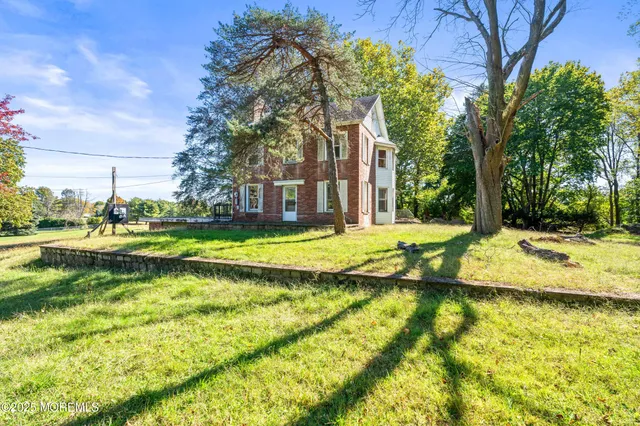 a view of swimming pool with lawn chairs and plants