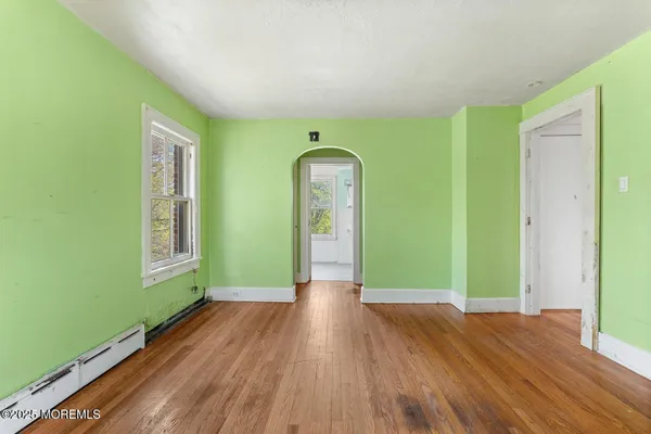 a view of a room with wooden floor entryway and windows