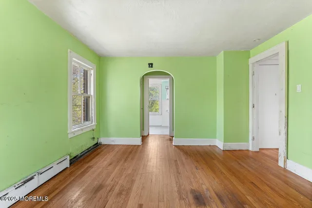 a view of a room with wooden floor entryway and windows