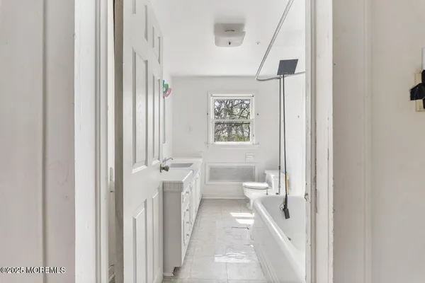 a bathroom with a toilet sink and a mirror