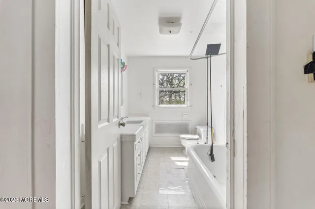 a bathroom with a toilet sink and a mirror