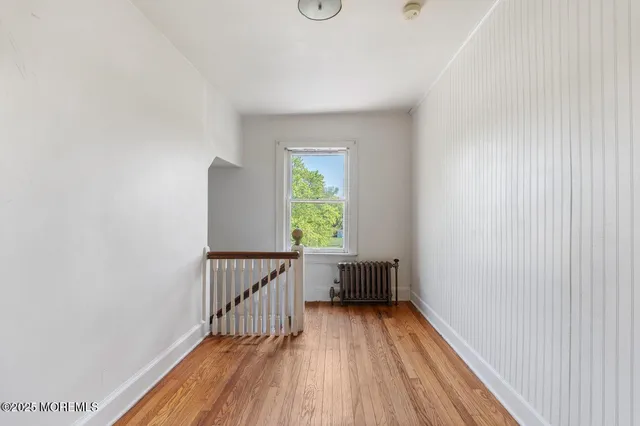 a view of hallway with wooden floor