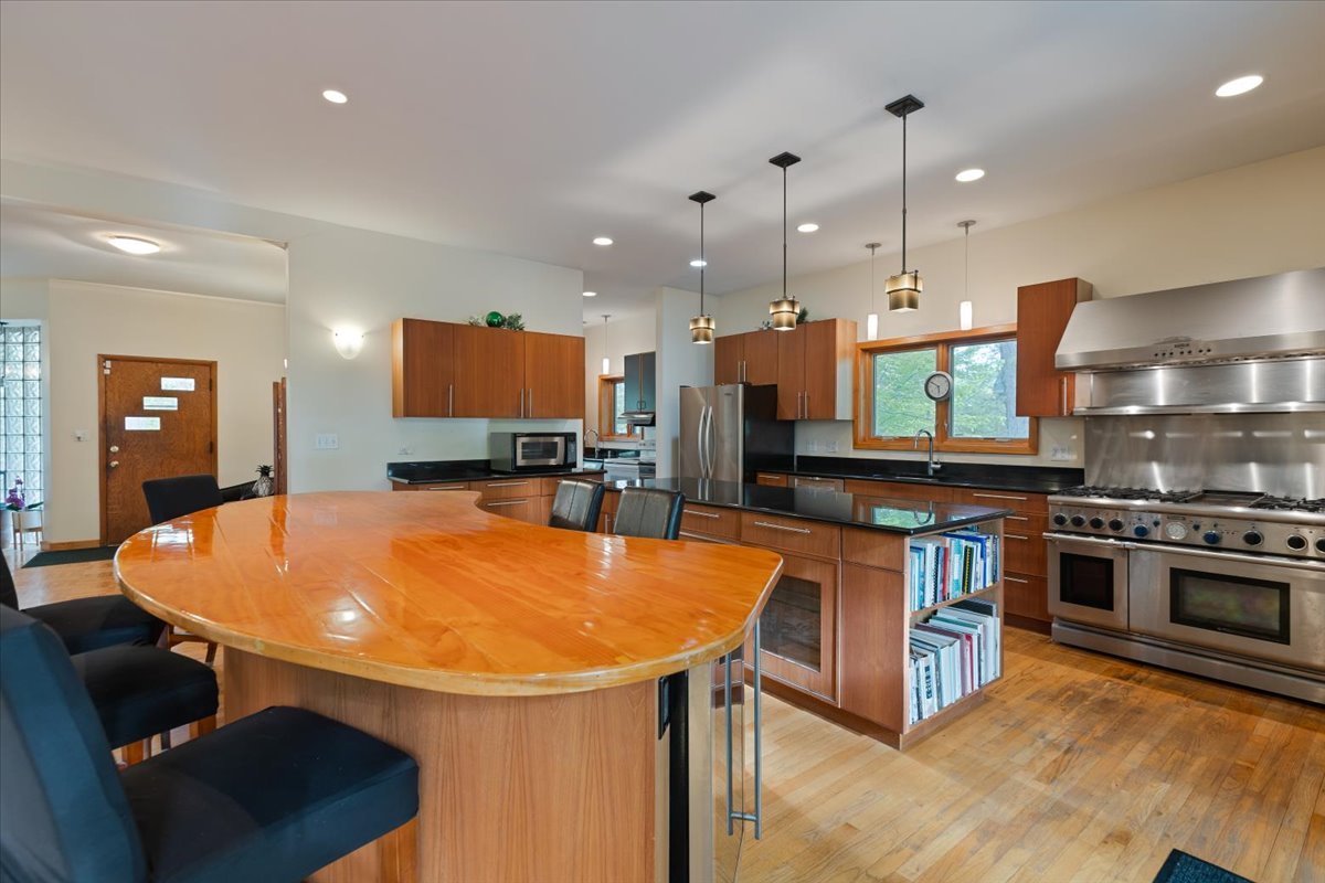 3464 Old Mill Road North Highland Park, IL 60035 - Photo 12 of 64 a kitchen with stainless steel appliances granite countertop a sink a stove and a wooden floors