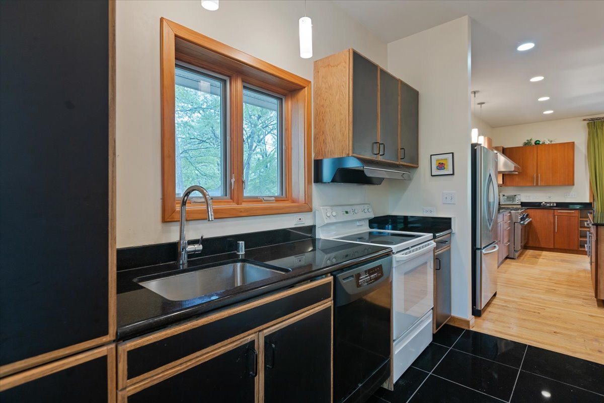 3464 Old Mill Road North Highland Park, IL 60035 - Photo 16 of 64 a kitchen with stainless steel appliances granite countertop a sink and a stove
