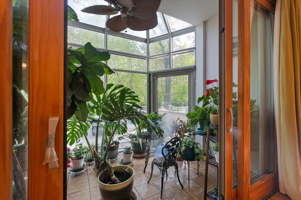 3464 Old Mill Road North Highland Park, IL 60035 - Photo 20 of 64 a glass vase with flowers sitting on a table and a potted plant