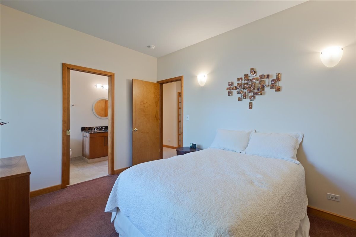 3464 Old Mill Road North Highland Park, IL 60035 - Photo 35 of 64 a bedroom with a large bed and a chandelier