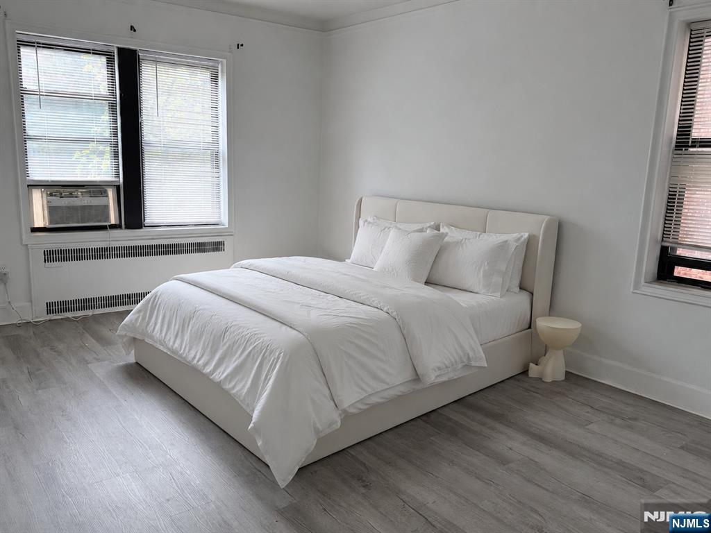 100 Prospect Avenue, Unit 2E Hackensack, NJ 07601 - Photo 14 of 16 a large bed sitting in a bedroom next to a window