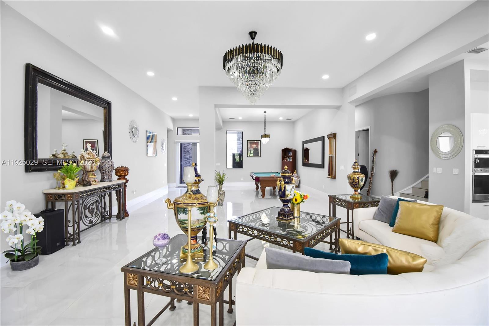 15846 Southwest 49th Street Southwest Ranches, FL 33331 - Photo 11 of 38 a living room with furniture a chandelier and a dining table