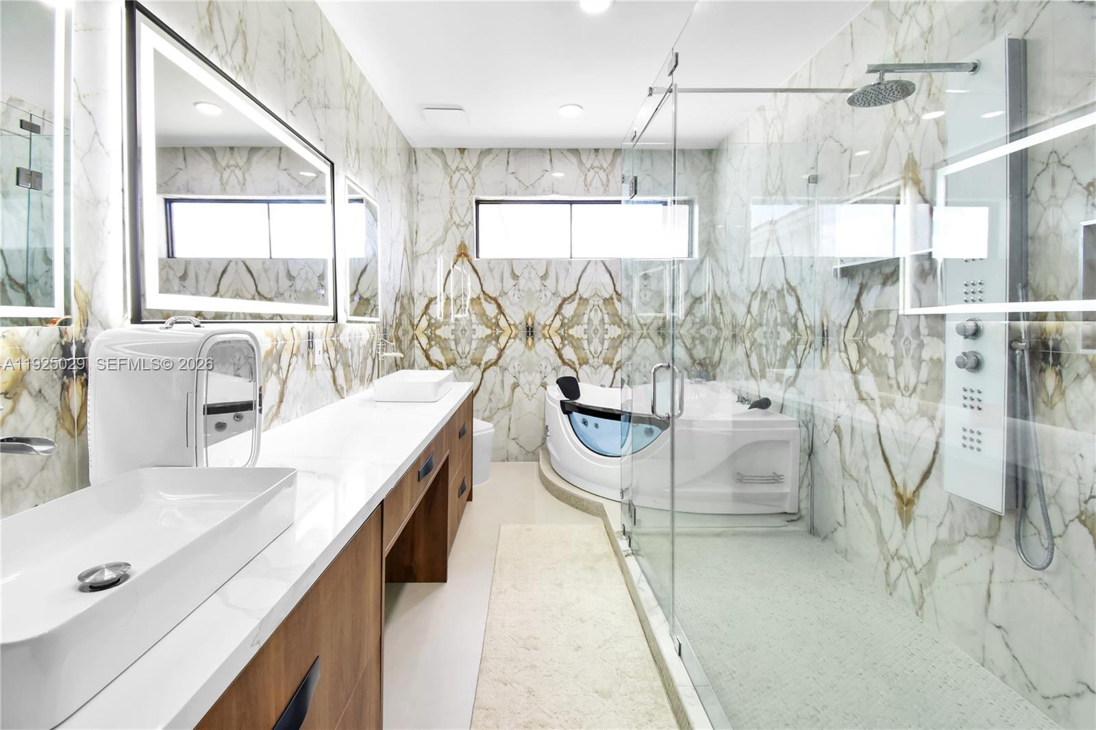 15846 Southwest 49th Street Southwest Ranches, FL 33331 - Photo 15 of 38 a spacious bathroom with a double vanity sink a mirror and a bathtub