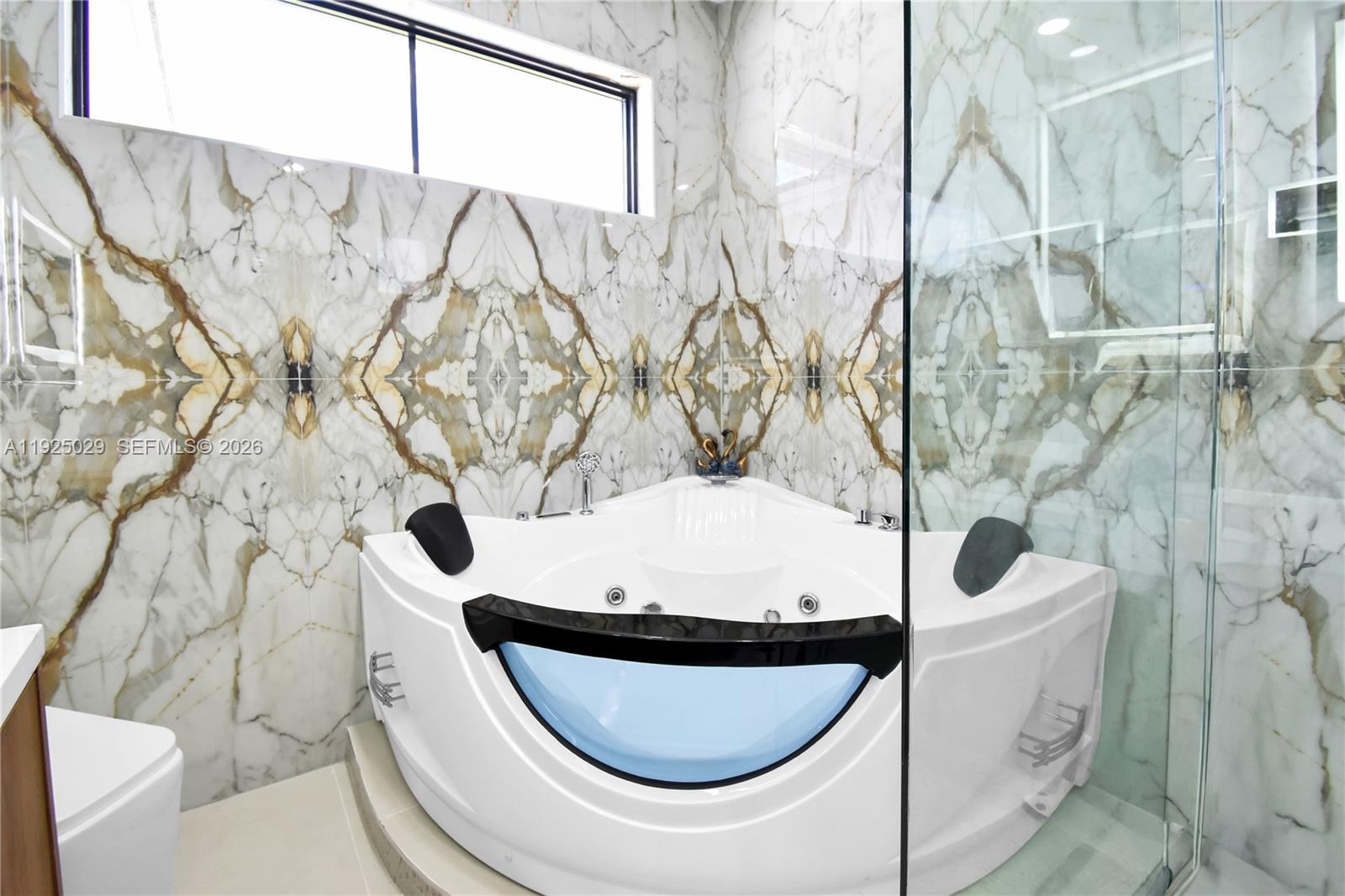 15846 Southwest 49th Street Southwest Ranches, FL 33331 - Photo 16 of 38 a bathroom with a toilet and a tub