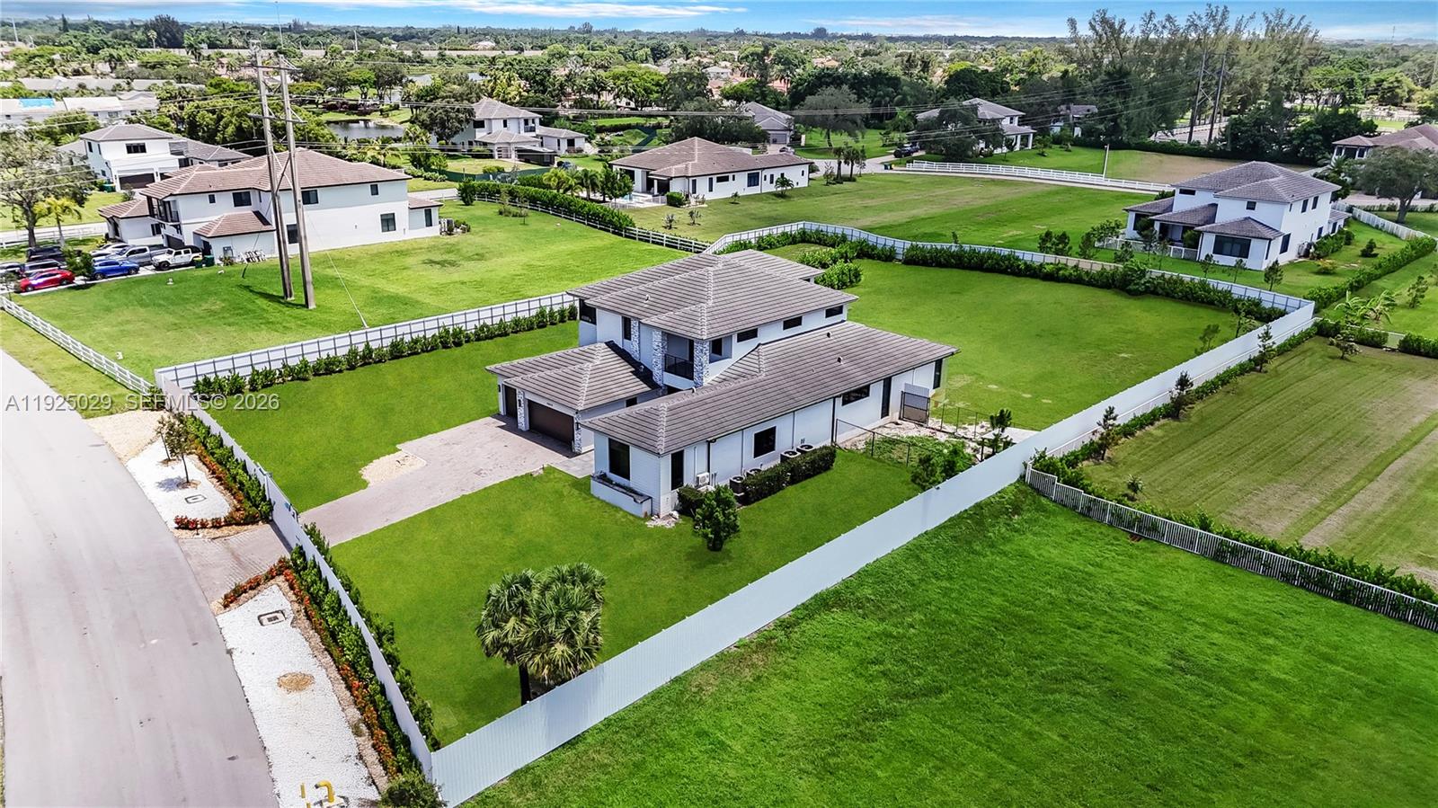 15846 Southwest 49th Street Southwest Ranches, FL 33331 - Photo 2 of 38 an aerial view of a residential houses with outdoor space and street view