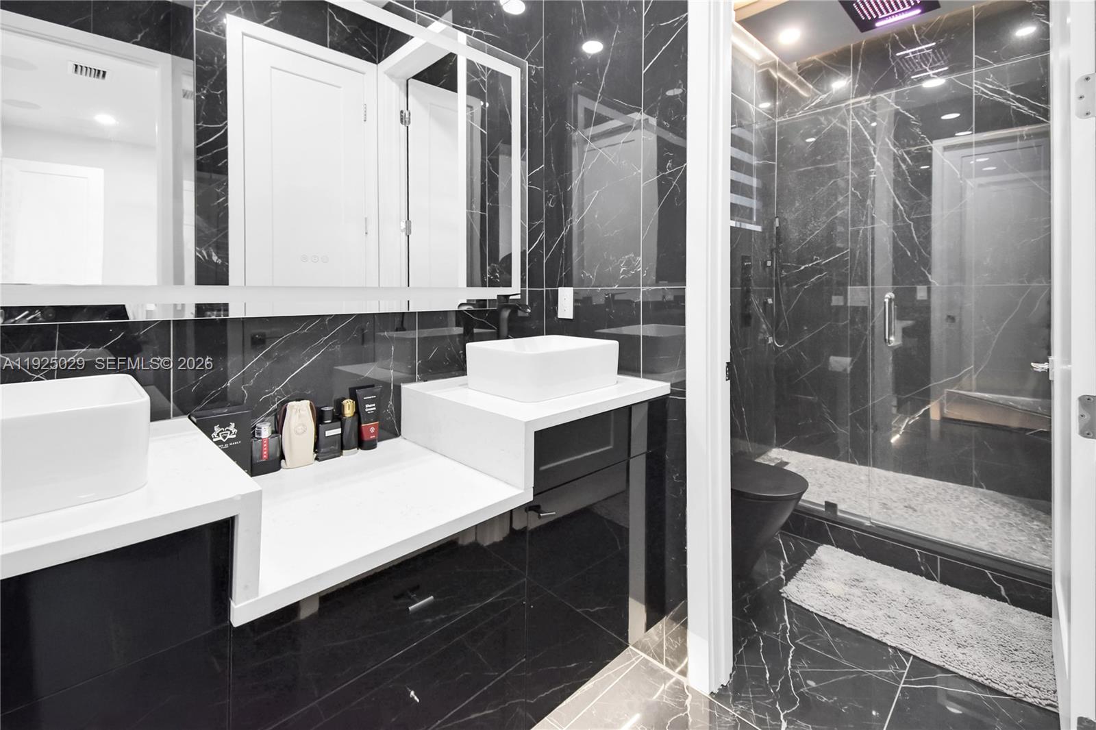 15846 Southwest 49th Street Southwest Ranches, FL 33331 - Photo 27 of 38 a bathroom with a double vanity sink a toilet and a mirror