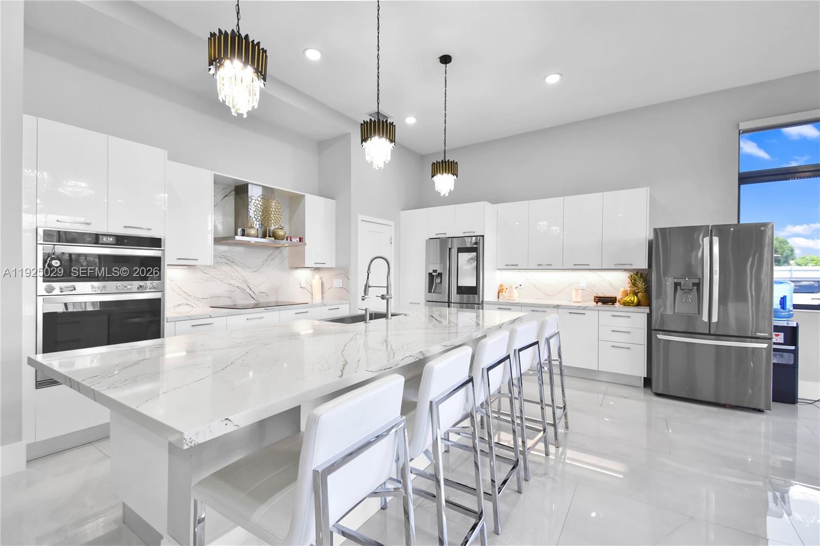 15846 Southwest 49th Street Southwest Ranches, FL 33331 - Photo 3 of 38 a large kitchen with a table and chairs