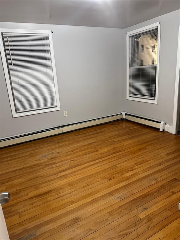 16 Sargent Street, Unit 1 Lawrence, MA 01841 - Photo 3 of 8 a view of an empty room with wooden floor and a window