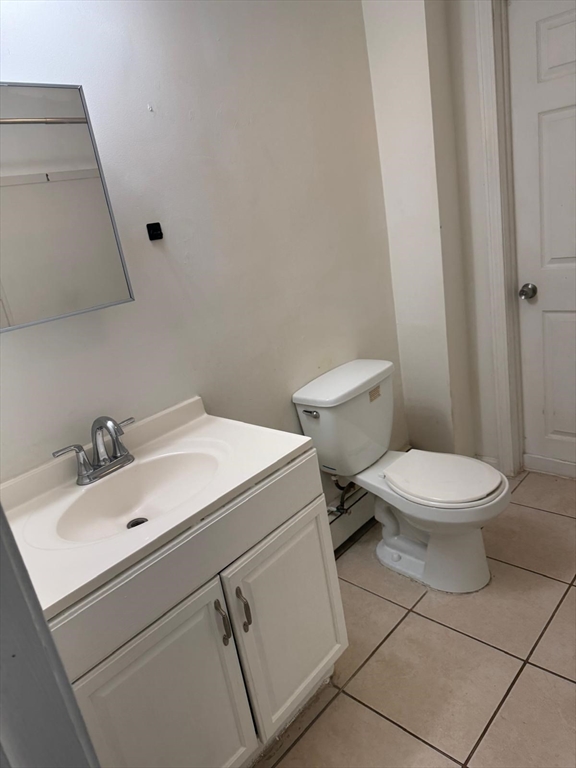 16 Sargent Street, Unit 1 Lawrence, MA 01841 - Photo 6 of 8 a bathroom with a toilet sink and mirror
