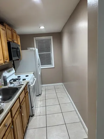 a kitchen with a sink and a stove top oven