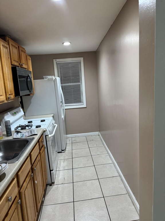 16 Sargent Street, Unit 1 Lawrence, MA 01841 - Photo 7 of 8 a kitchen with a sink and a stove top oven