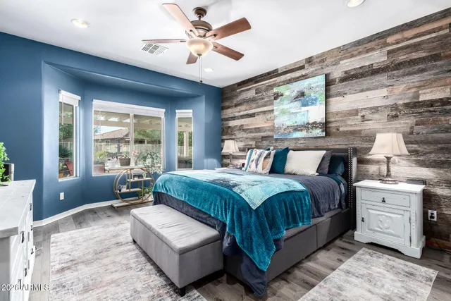 a bedroom with a large bed and a chandelier