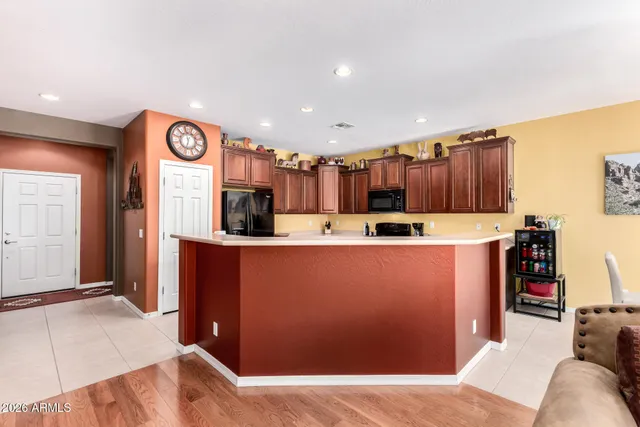 a kitchen with stainless steel appliances granite countertop a refrigerator and a stove top oven