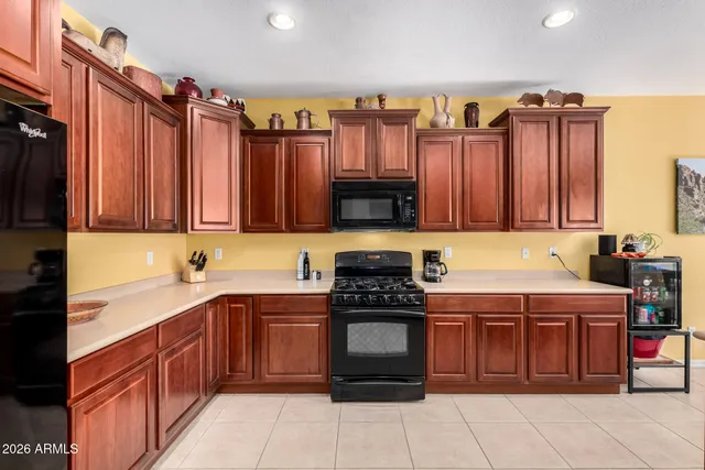 a kitchen with stainless steel appliances a stove a sink and a microwave