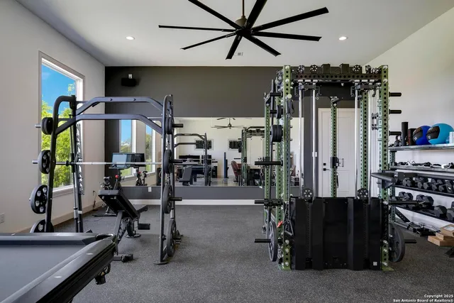 a view of a big house with a big yard and large tree