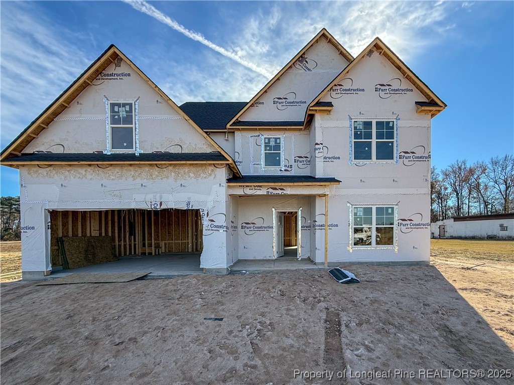 a view of a house with a yard and garage